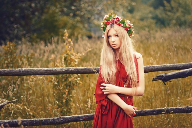 Young woman with straight hair wearing a red dress