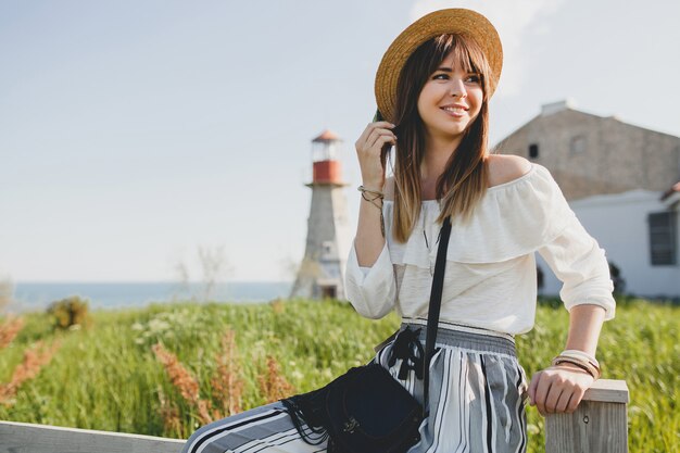 Young woman with straw hat in the countryside