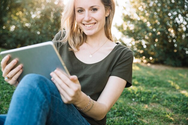 Young woman with tablet looking at camera