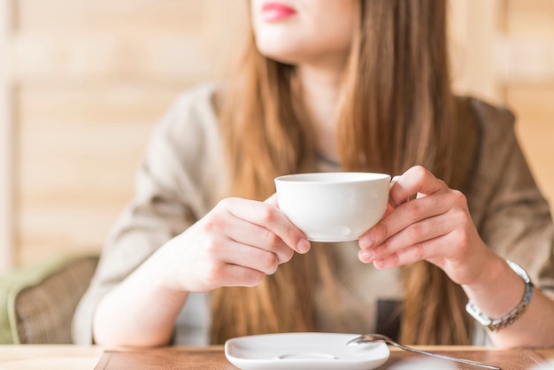 Young woman with a tea cup in her hands