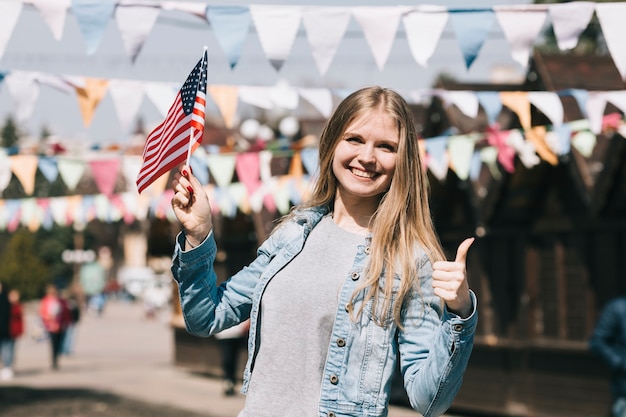 Free photo young woman with usa flag at festival