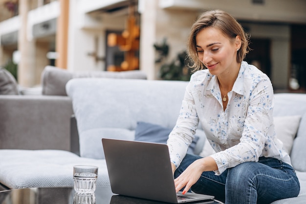 Free Photo young woman working on a computer at home