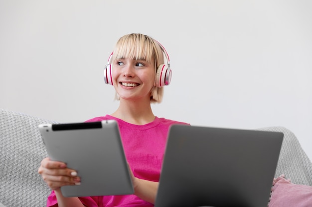 Free photo young woman working from home on her laptop