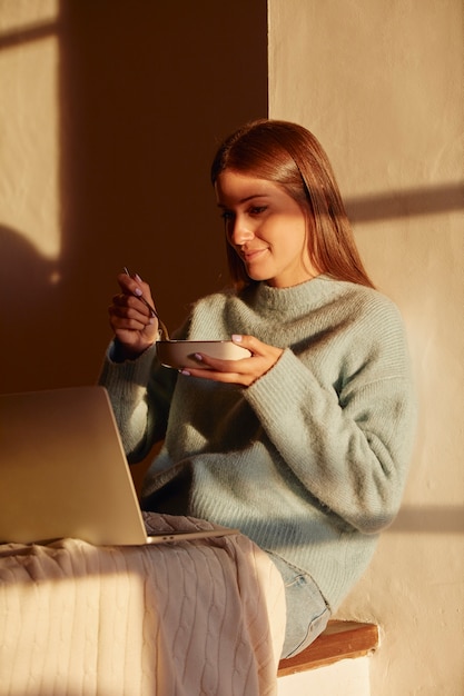 Free photo young woman working from home