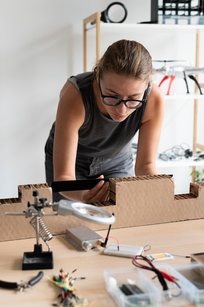 Young woman working in her workshop for a creative invention