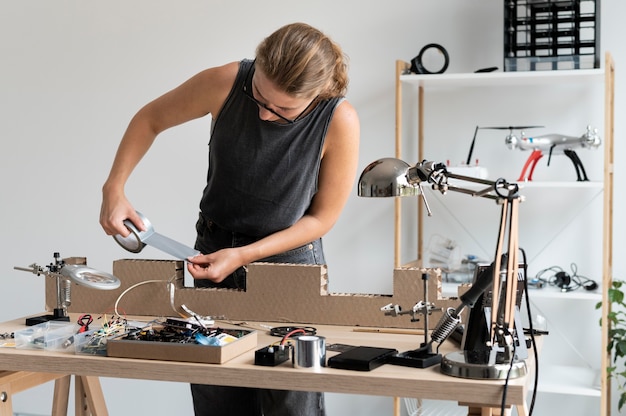 Young woman working in her workshop for a creative invention