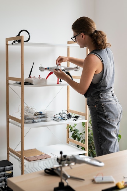 Young woman working in her workshop for a creative invention