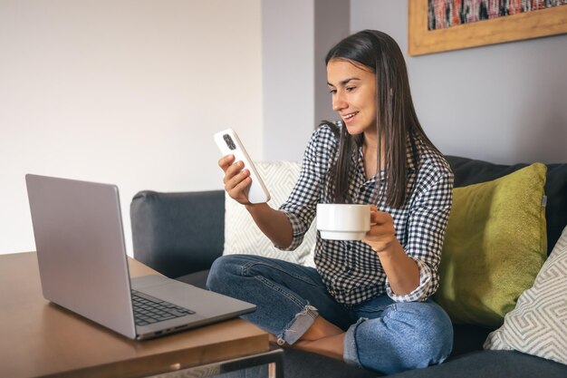 A young woman working on a laptop at home