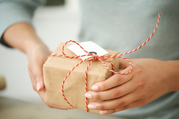 Young woman wrapping Christmas present