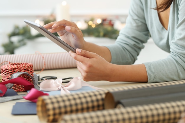 Young woman wrapping Christmas presents