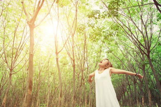 Young woman yawning in the forest