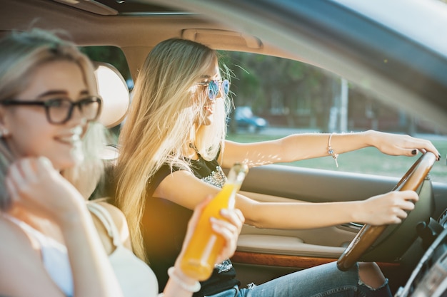 The young women in the car smiling