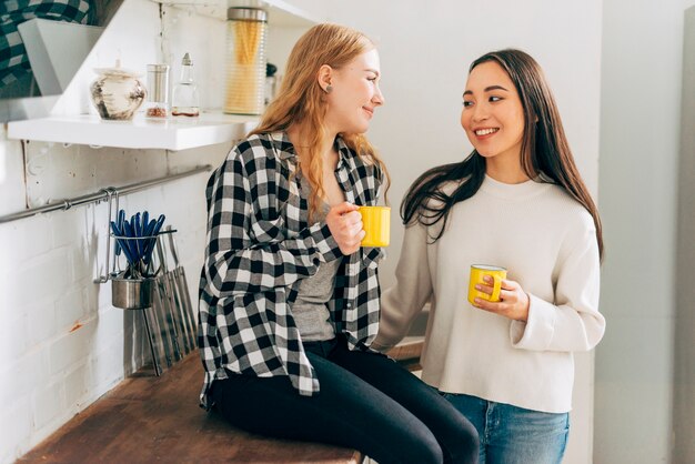 Young women chatting in kitchen