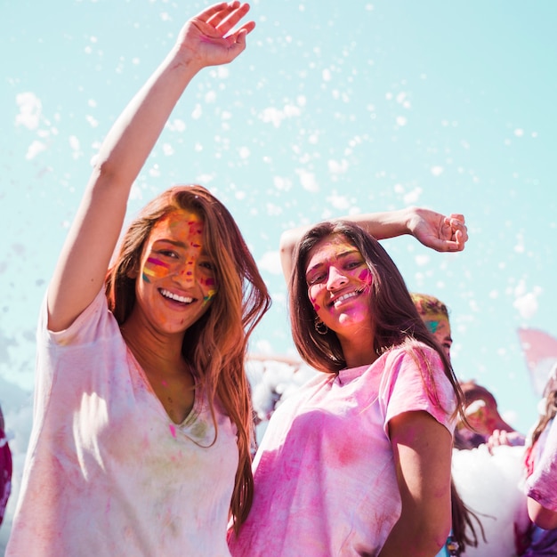 Young women dancing and enjoying the holi festival