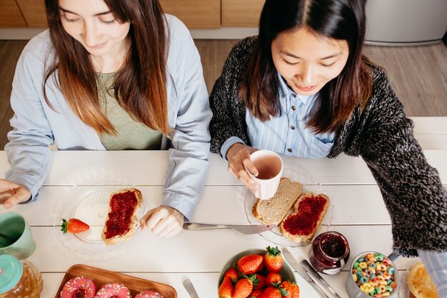 Young women enjoying sweet breakfast