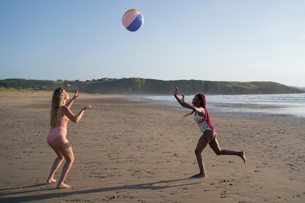 Free photo young women having fun at the beach