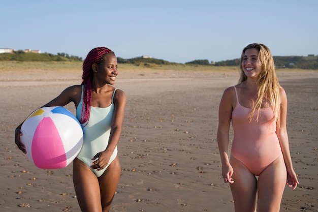 Free photo young women having fun at the beach