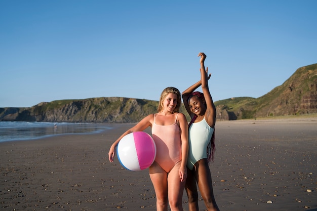 Free photo young women having fun at the beach