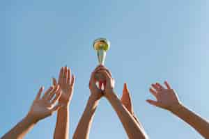 Free photo young women holding a sports cup