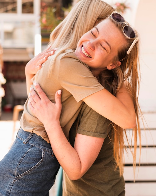 Young women hugging each other