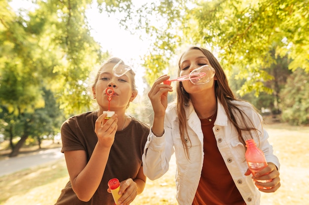 Free photo young women making soap bubbles