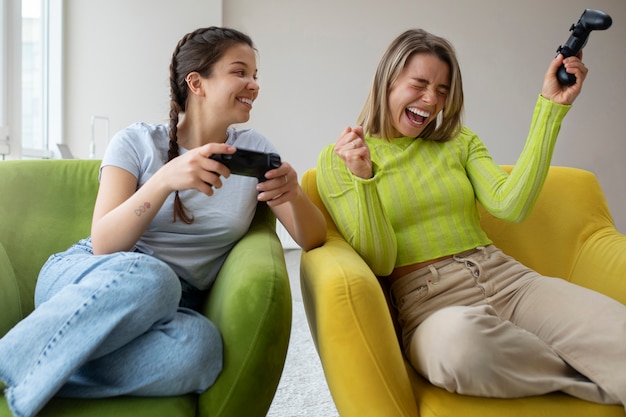 Free photo young women playing video games together