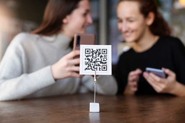 Young women scanning qr code at the cafeteria