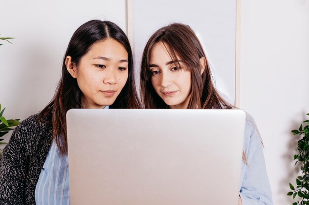 Young women standing with laptop