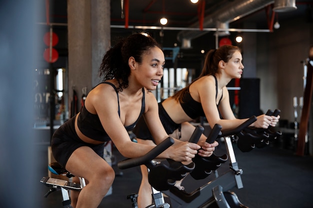 Young women taking part of spinning class