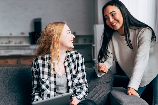 Young women talking at home