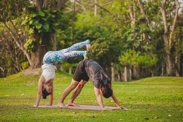 Young yoga lovers doing acrobatics