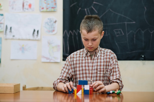 Free photo youngster in classroom with puzzle