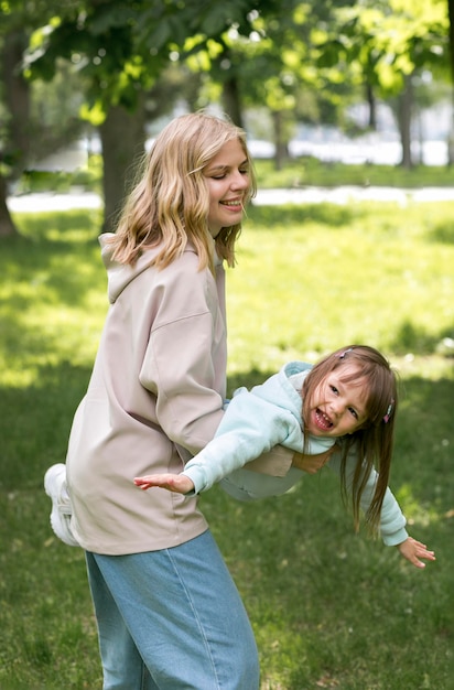 Free Photo youngster outdoors playing with mom