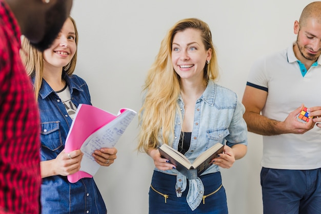 Free Photo youngsters with books talking