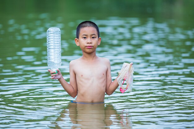 Youth collect garbage in the river, concept of National Youth Day and World Environment Day.