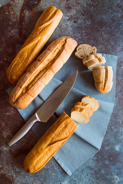 Yummy baguette on slate board top view