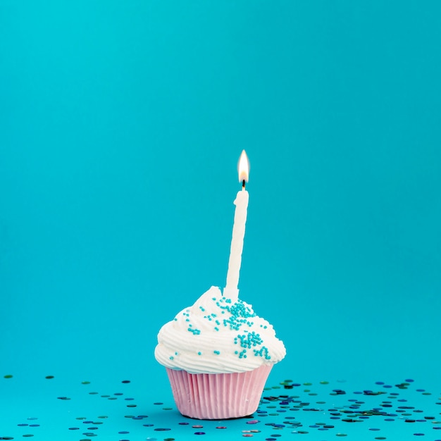 Free Photo yummy birthday muffin on blue background