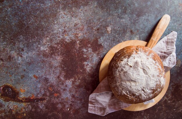 Yummy bun on rusted table top view