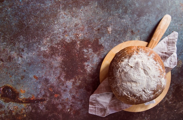 Yummy bun on rusted table top view