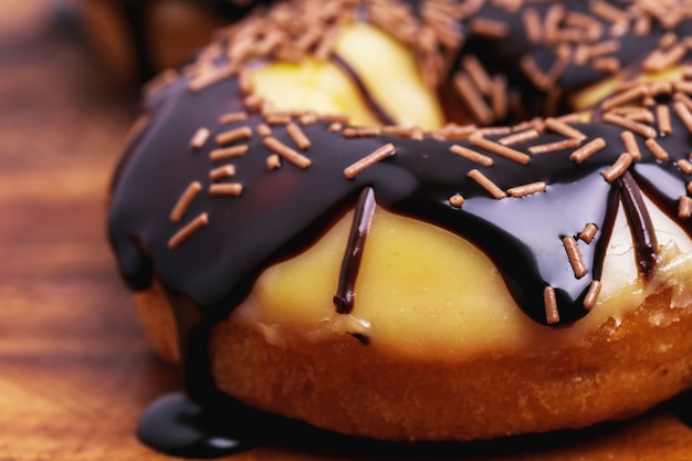 Yummy donuts on wooden board