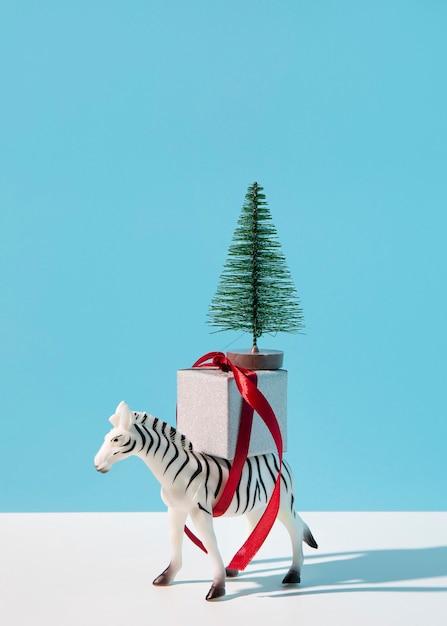 Free photo zebra with gift and fir tree