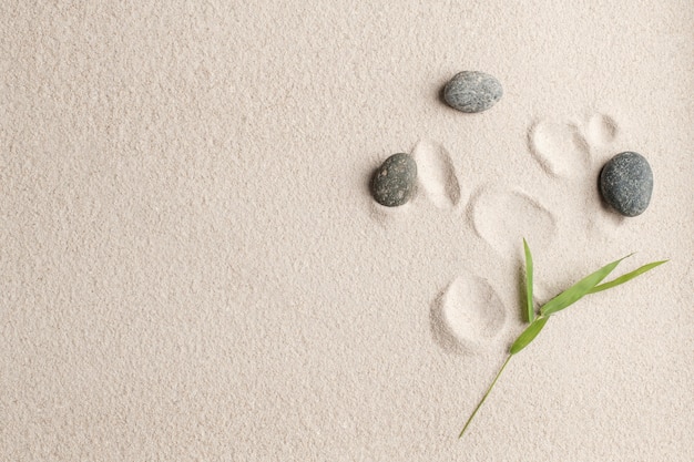 Free photo zen stones sand background health and wellness concept