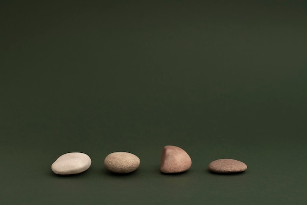 Free Photo zen stones stacked on green background in health and wellbeing concept