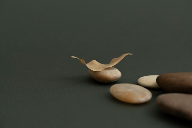 Free Photo zen stones stacked on green background in health and wellbeing concept