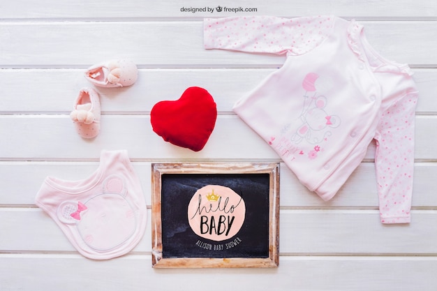 Baby mockup with girl clothes and slate