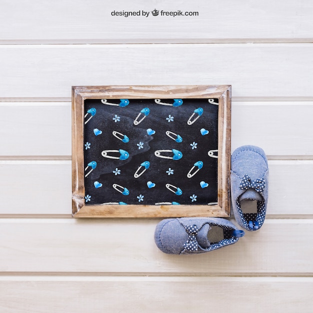 Free PSD baby mockup with slate and shoes