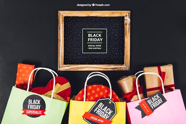 Free PSD black friday mockup with slate and bags full of presents