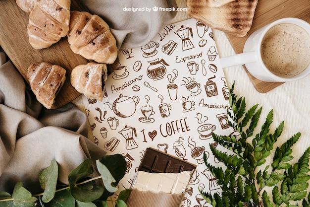 Breakfast mockup with paper, croissants and mug