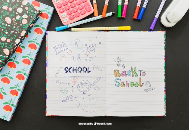 Free PSD colorful drawing on the notebook with school material