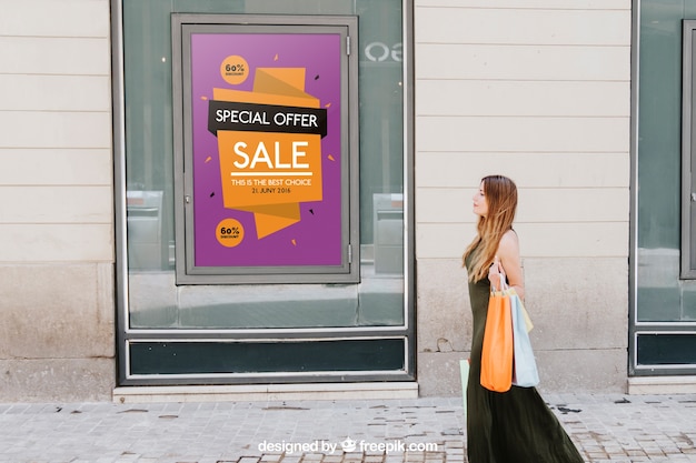 Design of mock up with sales poster and woman in the street